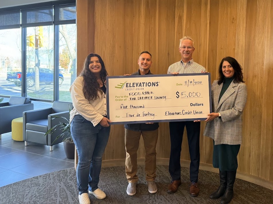 Elevations team members holding a $5,000 check for local food bank Elevations team members holding a $5,000 check for local food bank