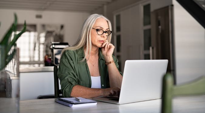 Woman sitting with laptop and thinking. 