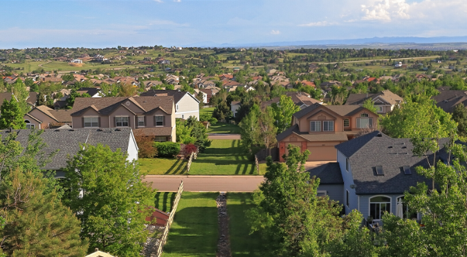 Houses in a vast green land.