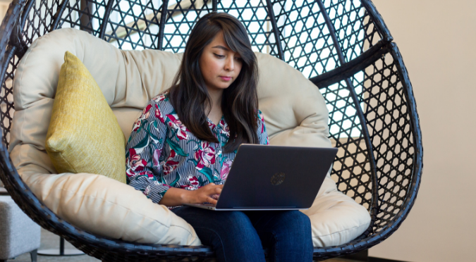 Woman sitting working on laptop