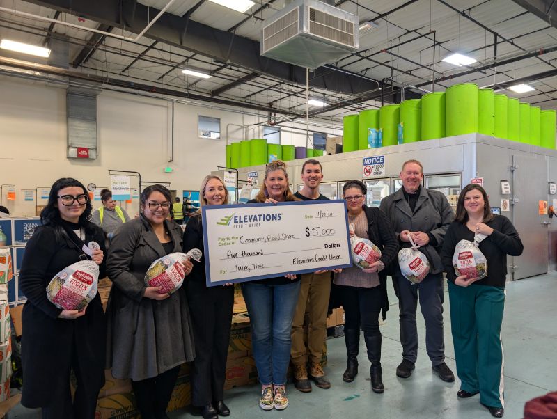 Elevations team members holding a $10,000 check for Thanksgiving Food Drive