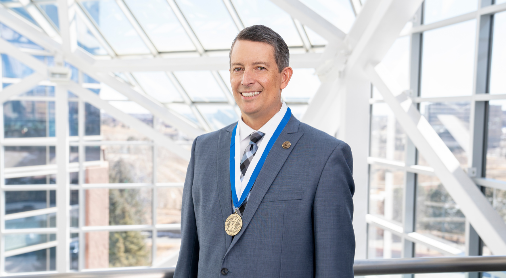 Man in a suit with a medal.